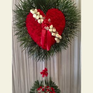 H0700: Red carnation broken heart with palm leaf